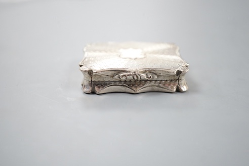 An early Victorian engine turned silver shaped rectangular vinaigrette, by Nathaniel Mills, Birmingham, 1843, 36mm, in leather box.